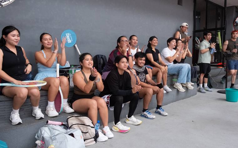 Members cheering courtside at an open play